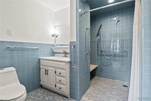 79 Windermere Blvd, Amherst, NY 14226 - bathroom featuring vanity, tiled shower, toilet, tile patterned flooring, and tile walls