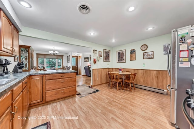 393 Bauman Rd, Amherst, NY 14221 - kitchen with freestanding refrigerator, a baseboard radiator, a wainscoted wall, light wood-type flooring, and a chandelier