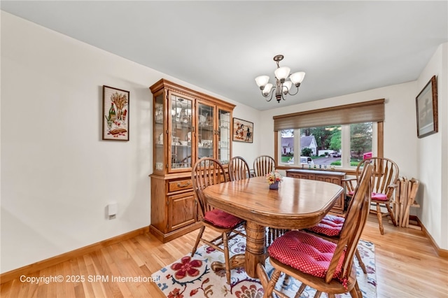 393 Bauman Rd, Amherst, NY 14221 - dining space with baseboards, a chandelier, and light wood finished floors