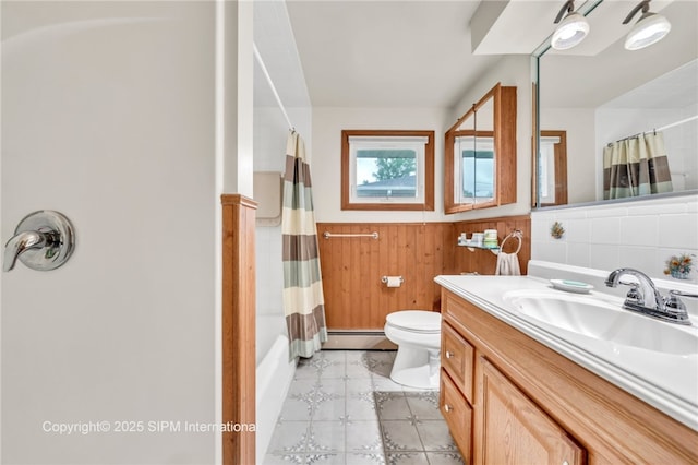 393 Bauman Rd, Amherst, NY 14221 - full bathroom with a baseboard heating unit, wainscoting, toilet, vanity, and shower / bath combo with shower curtain