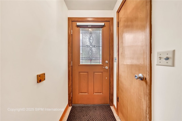 393 Bauman Rd, Amherst, NY 14221 - doorway to outside featuring tile patterned floors and baseboards