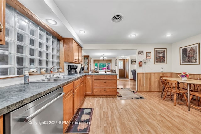 393 Bauman Rd, Amherst, NY 14221 - kitchen featuring dishwasher, a sink, a peninsula, light wood-style flooring, and a wainscoted wall