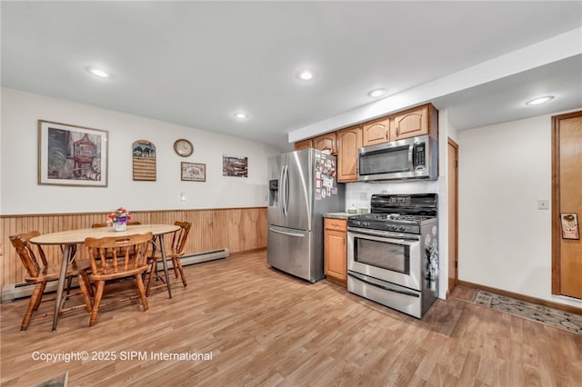 393 Bauman Rd, Amherst, NY 14221 - kitchen featuring stainless steel appliances, a wainscoted wall, light wood finished floors, a baseboard radiator, and recessed lighting