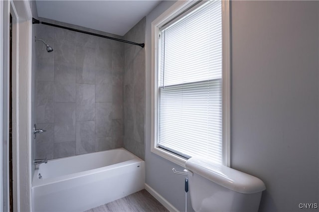 611 Turin St, Rome-Inside, NY 13440 - bathroom with toilet,  shower combination, baseboards, and wood finished floors