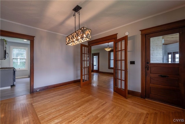 611 Turin St, Rome-Inside, NY 13440 - unfurnished dining area featuring french doors, a chandelier, baseboards, crown molding, and light wood finished floors