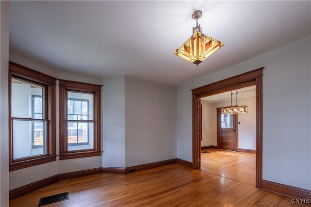 611 Turin St, Rome-Inside, NY 13440 - unfurnished room with baseboards, a chandelier, and light wood-type flooring
