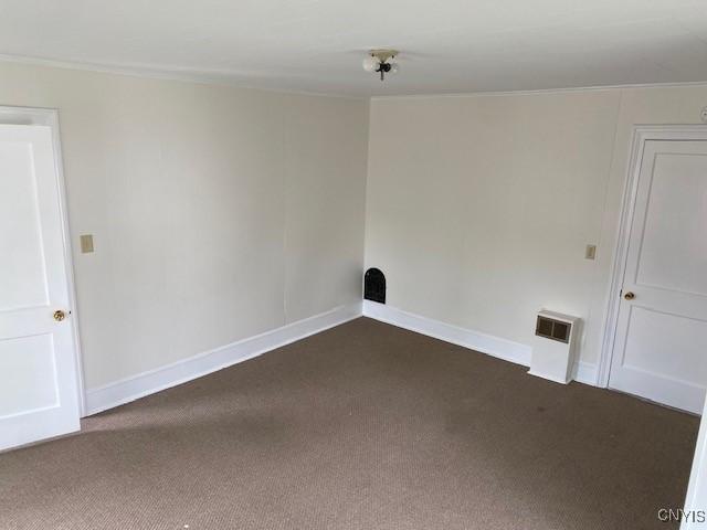 3 Genesee St, New Berlin, NY 13411 - empty room with dark colored carpet, baseboards, and ornamental molding