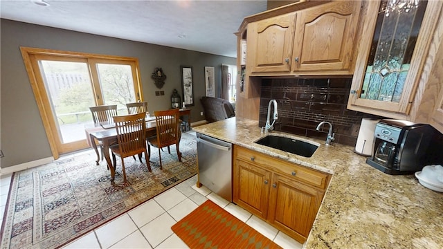 7404 Bonney Hill Rd, Hamilton, NY 13346 - kitchen featuring stainless steel dishwasher, decorative backsplash, a sink, light stone countertops, and light tile patterned flooring