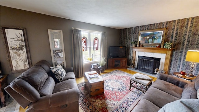 7404 Bonney Hill Rd, Hamilton, NY 13346 - living area featuring a tiled fireplace, wood finished floors, wallpapered walls, and an accent wall