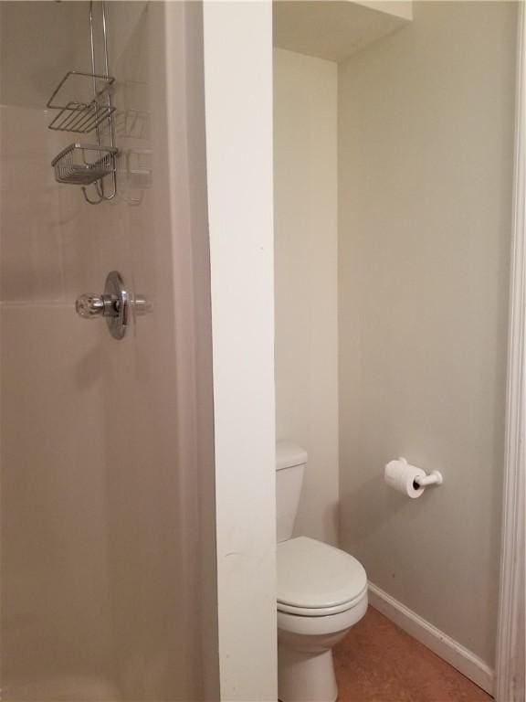 7404 Bonney Hill Rd, Hamilton, NY 13346 - bathroom with a shower stall, toilet, and baseboards