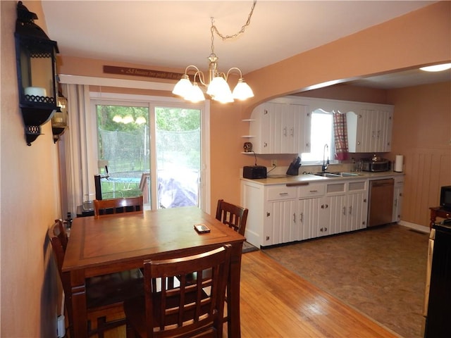 908 W 2nd St, Elmira, NY 14905 - dining space with a chandelier, plenty of natural light, and light wood finished floors