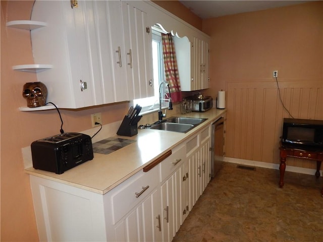 908 W 2nd St, Elmira, NY 14905 - kitchen with a sink, dishwasher, white cabinetry, light countertops, and light floors