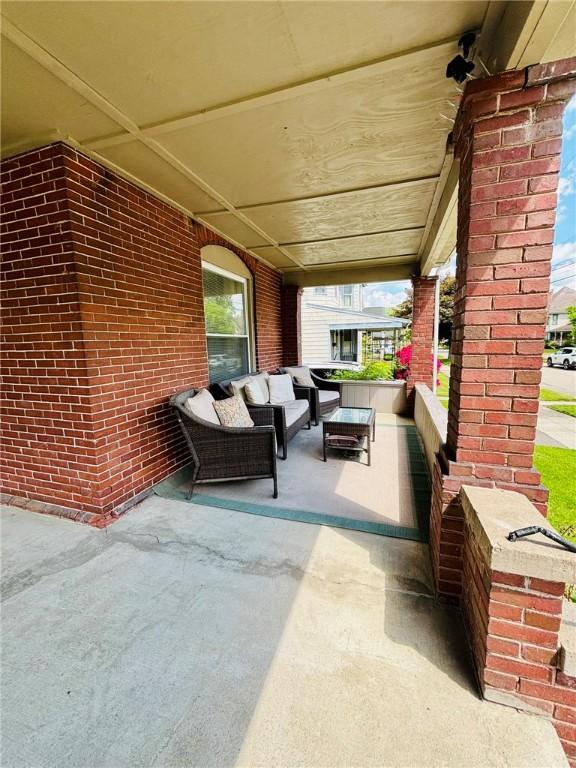 145 Decatur St, Corning-City, NY 14830 - covered porch featuring an outdoor living space
