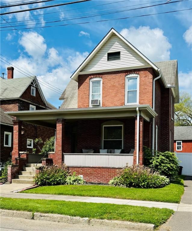 145 Decatur St, Corning-City, NY 14830 - view of front facade with a porch, brick siding, and cooling unit
