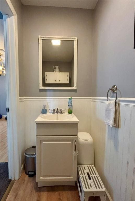 145 Decatur St, Corning-City, NY 14830 - bathroom featuring a wainscoted wall, vanity, wood finished floors, and toilet