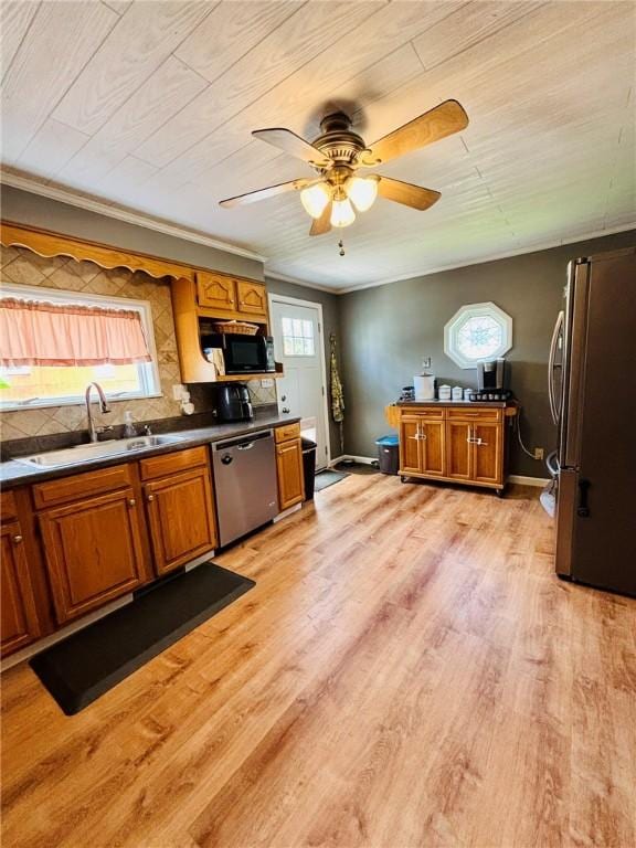 145 Decatur St, Corning-City, NY 14830 - kitchen with appliances with stainless steel finishes, a sink, brown cabinetry, light wood finished floors, and ceiling fan