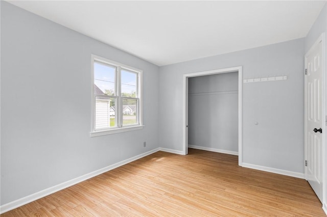2200 W Henrietta Rd, Brighton, NY 14623 - unfurnished bedroom featuring light wood finished floors, baseboards, and a closet