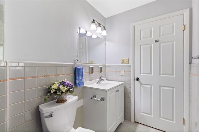 2200 W Henrietta Rd, Brighton, NY 14623 - bathroom featuring tile walls, vanity, toilet, wainscoting, and tile patterned flooring