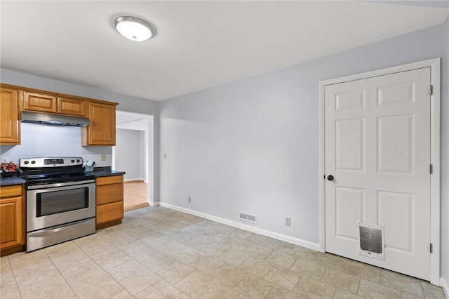 2200 W Henrietta Rd, Brighton, NY 14623 - kitchen featuring stainless steel electric stove, under cabinet range hood, dark countertops, baseboards, and brown cabinets