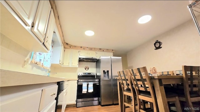 48 Presidio Pl, Amherst, NY 14221 - kitchen with stainless steel appliances, under cabinet range hood, light wood-style flooring, light countertops, and white cabinetry