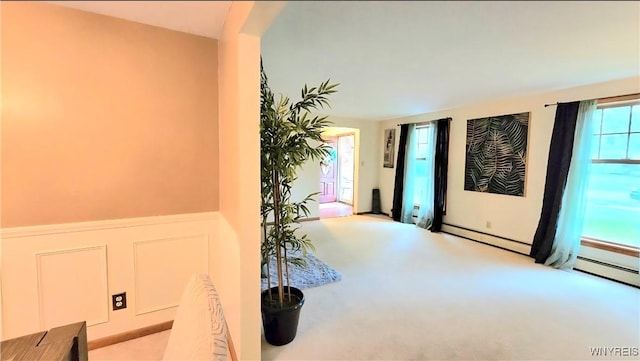 48 Presidio Pl, Amherst, NY 14221 - foyer entrance with healthy amount of natural light, carpet floors, a wainscoted wall, a decorative wall, and a baseboard radiator
