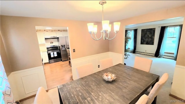 48 Presidio Pl, Amherst, NY 14221 - dining area with a chandelier, wainscoting, and a baseboard heating unit