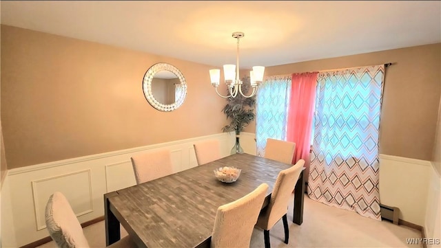 48 Presidio Pl, Amherst, NY 14221 - dining area featuring a baseboard heating unit, a chandelier, a wainscoted wall, a decorative wall, and carpet floors