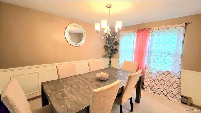 48 Presidio Pl, Amherst, NY 14221 - carpeted dining area with baseboard heating, a chandelier, a wainscoted wall, and a decorative wall