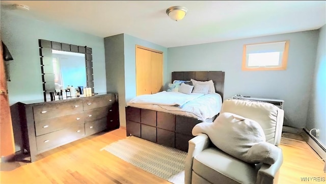 48 Presidio Pl, Amherst, NY 14221 - bedroom featuring light wood-style floors, a baseboard heating unit, and a closet