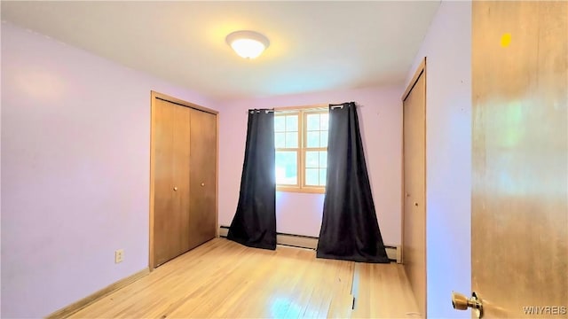 48 Presidio Pl, Amherst, NY 14221 - unfurnished bedroom featuring light wood-style floors, baseboard heating, and a closet