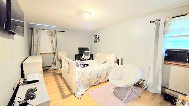 48 Presidio Pl, Amherst, NY 14221 - bedroom featuring wood finished floors, cooling unit, and a baseboard radiator