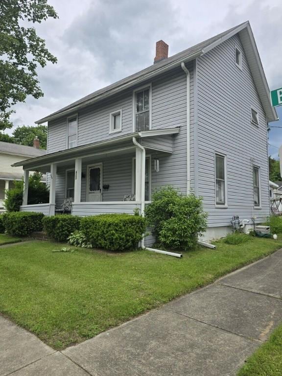 600 Beach St, Elmira-City, NY 14901 - view of front facade with a chimney, covered porch, and a front yard