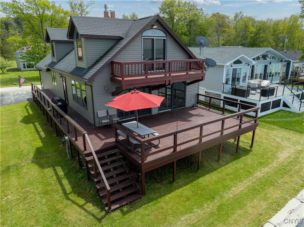 158 Rikers Beach Rd, Scriba, NY 13126 - back of property featuring a wooden deck, a yard, and a shingled roof