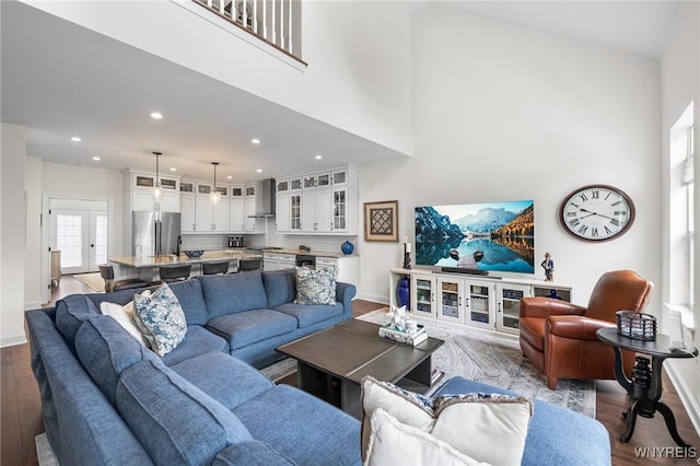 107 California Dr Unit G, Amherst, NY 14221 - living area with baseboards, dark wood finished floors, a towering ceiling, and recessed lighting
