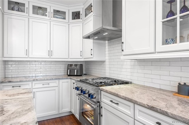 107 California Dr Unit G, Amherst, NY 14221 - kitchen featuring wall chimney exhaust hood, high end stainless steel range oven, white cabinetry, and light stone counters