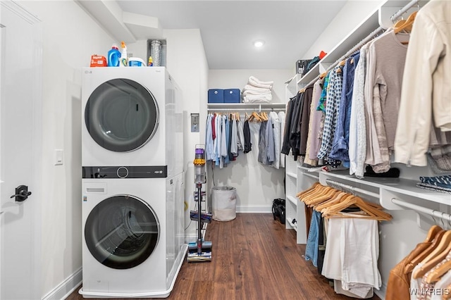 107 California Dr Unit G, Amherst, NY 14221 - laundry room with stacked washing machine and dryer, wood finished floors, and baseboards