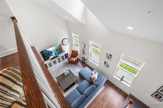 107 California Dr Unit G, Amherst, NY 14221 - living room featuring plenty of natural light, a towering ceiling, baseboards, wood finished floors, and recessed lighting