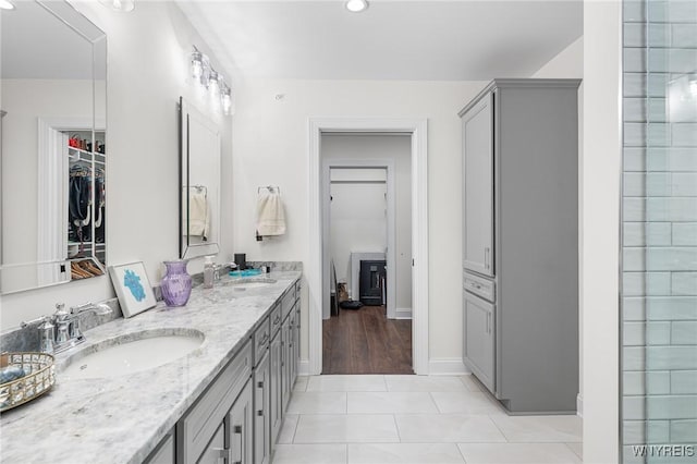 107 California Dr Unit G, Amherst, NY 14221 - bathroom with double vanity, tile patterned floors, baseboards, a spacious closet, and recessed lighting