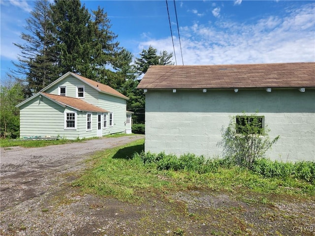 768 Crow Hill Rd, Skaneateles, NY 13152 - view of side of home with dirt driveway and a shingled roof