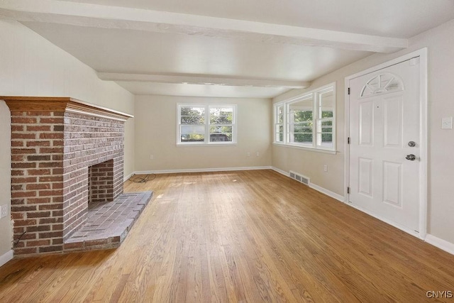 109 Wilkie Pl, Syracuse, NY 13203 - unfurnished living room featuring beam ceiling, light wood-type flooring, baseboards, and a fireplace