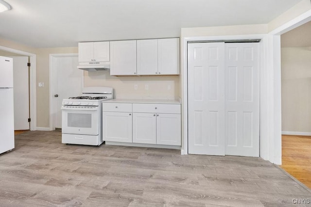 109 Wilkie Pl, Syracuse, NY 13203 - kitchen with white appliances, under cabinet range hood, white cabinets, light countertops, and baseboards