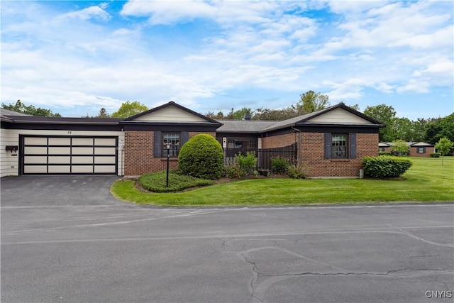 24 The Orch, Manlius, NY 13066 - ranch-style home featuring driveway, brick siding, an attached garage, and a front yard