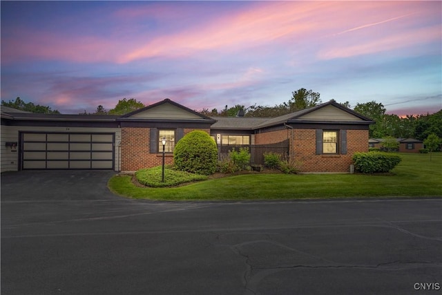 24 The Orch, Manlius, NY 13066 - ranch-style home with brick siding, driveway, an attached garage, and a lawn