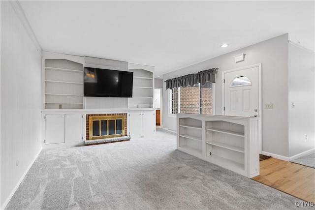 24 The Orch, Manlius, NY 13066 - unfurnished living room with baseboards, carpet, built in features, a brick fireplace, and recessed lighting