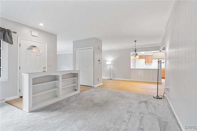 24 The Orch, Manlius, NY 13066 - unfurnished living room with light carpet, baseboards, recessed lighting, and crown molding