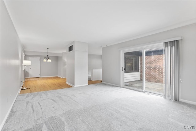 24 The Orch, Manlius, NY 13066 - unfurnished living room with carpet floors, a chandelier, and baseboards