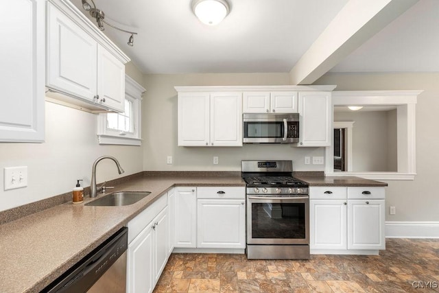 264 S 5th St, Fulton, NY 13069 - kitchen with appliances with stainless steel finishes, a sink, white cabinets, stone finish floors, and dark countertops