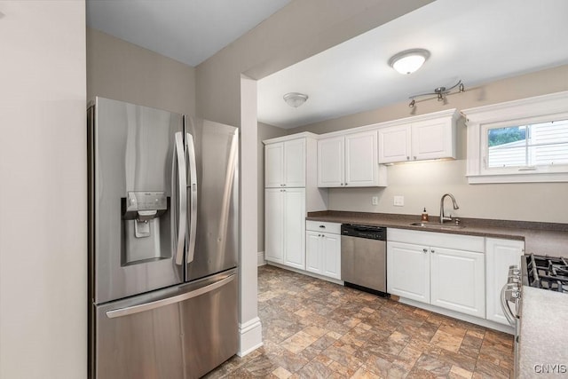264 S 5th St, Fulton, NY 13069 - kitchen with appliances with stainless steel finishes, a sink, stone finish floors, and white cabinets
