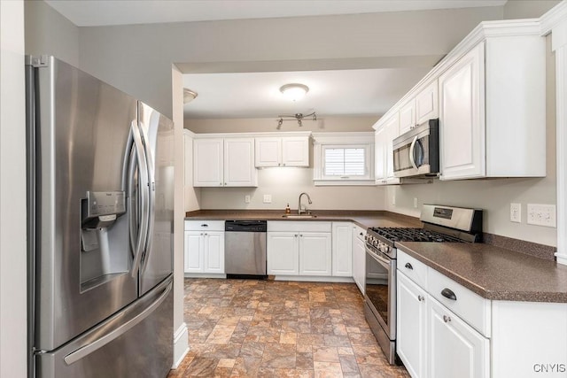264 S 5th St, Fulton, NY 13069 - kitchen with appliances with stainless steel finishes, dark countertops, a sink, and stone finish floors