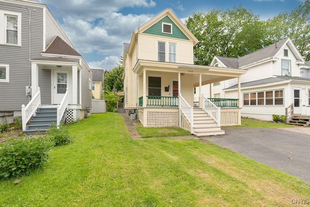 264 S 5th St, Fulton, NY 13069 - view of front of home featuring a porch, a front yard, and stairway